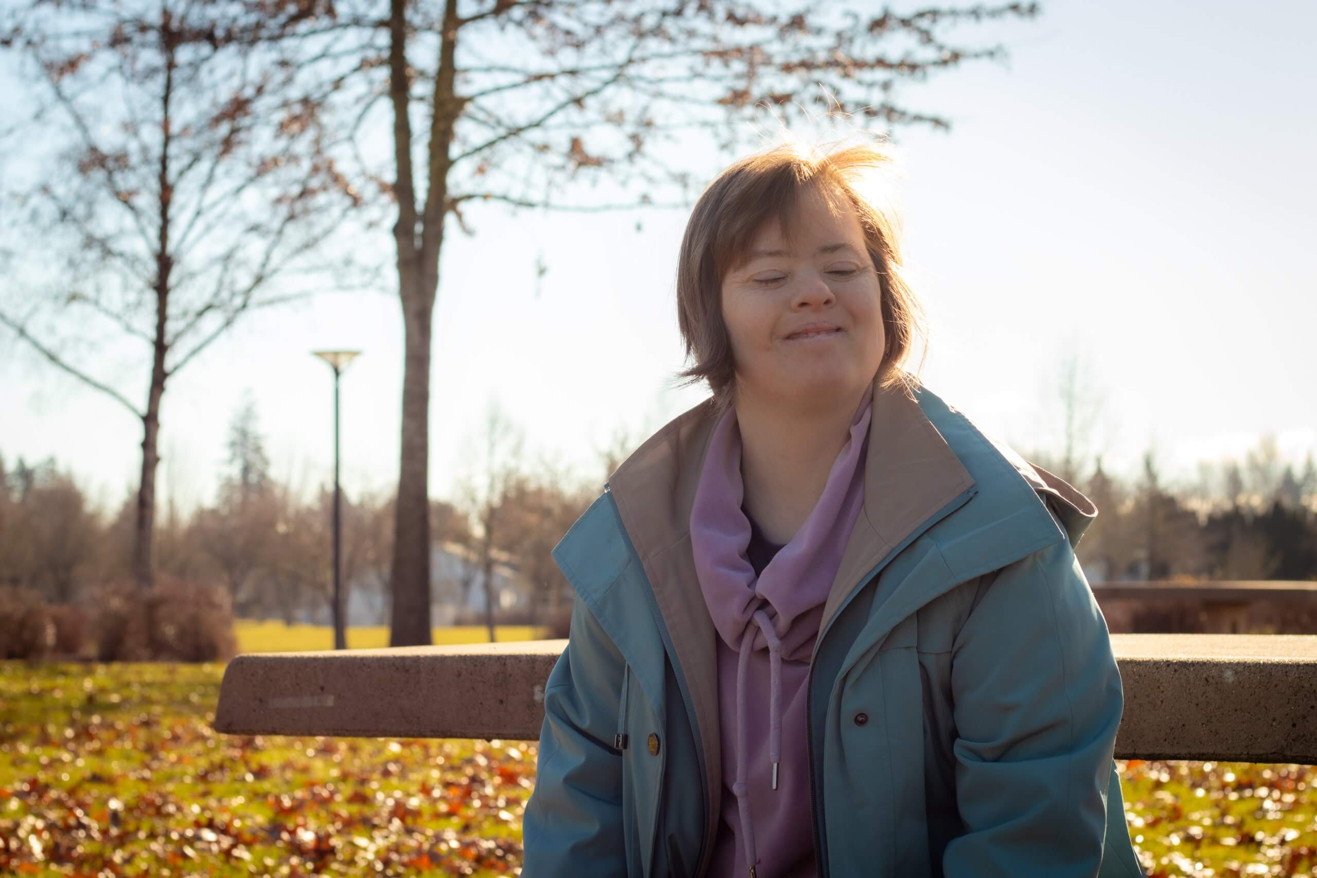 MVA Day in the Park Disability Services McMinnville Oregon Woman with down syndrome enjoying a sunny day in the park